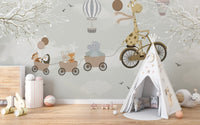 Soft illustrative wall mural featuring a cycling giraffe and clouds for a nursery.