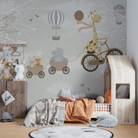 Pastel animal adventure wall mural in a sunlit room with a small wooden bed.