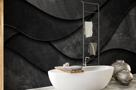 Dark charcoal 3D wave wall mural behind a white bathroom vanity