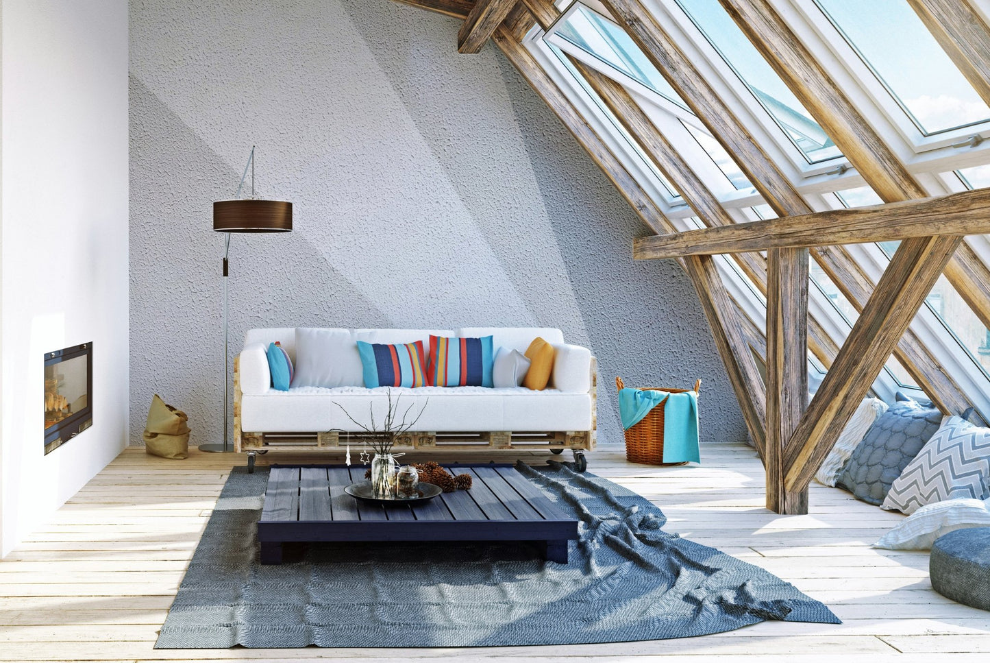 Abstract grey concrete wall mural in a spacious attic living area with skylights.