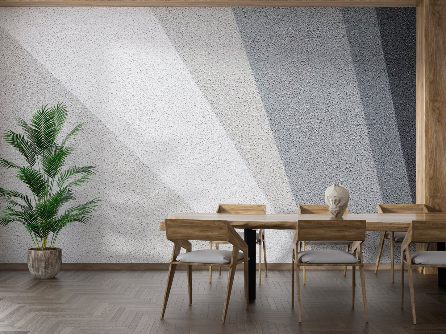 Geometric grey concrete wall mural behind a modern dining table and chairs.