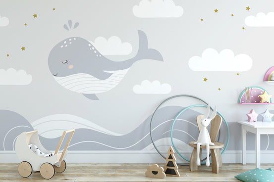 Sleeping whale wallpaper mural with gray ocean waves and stars.