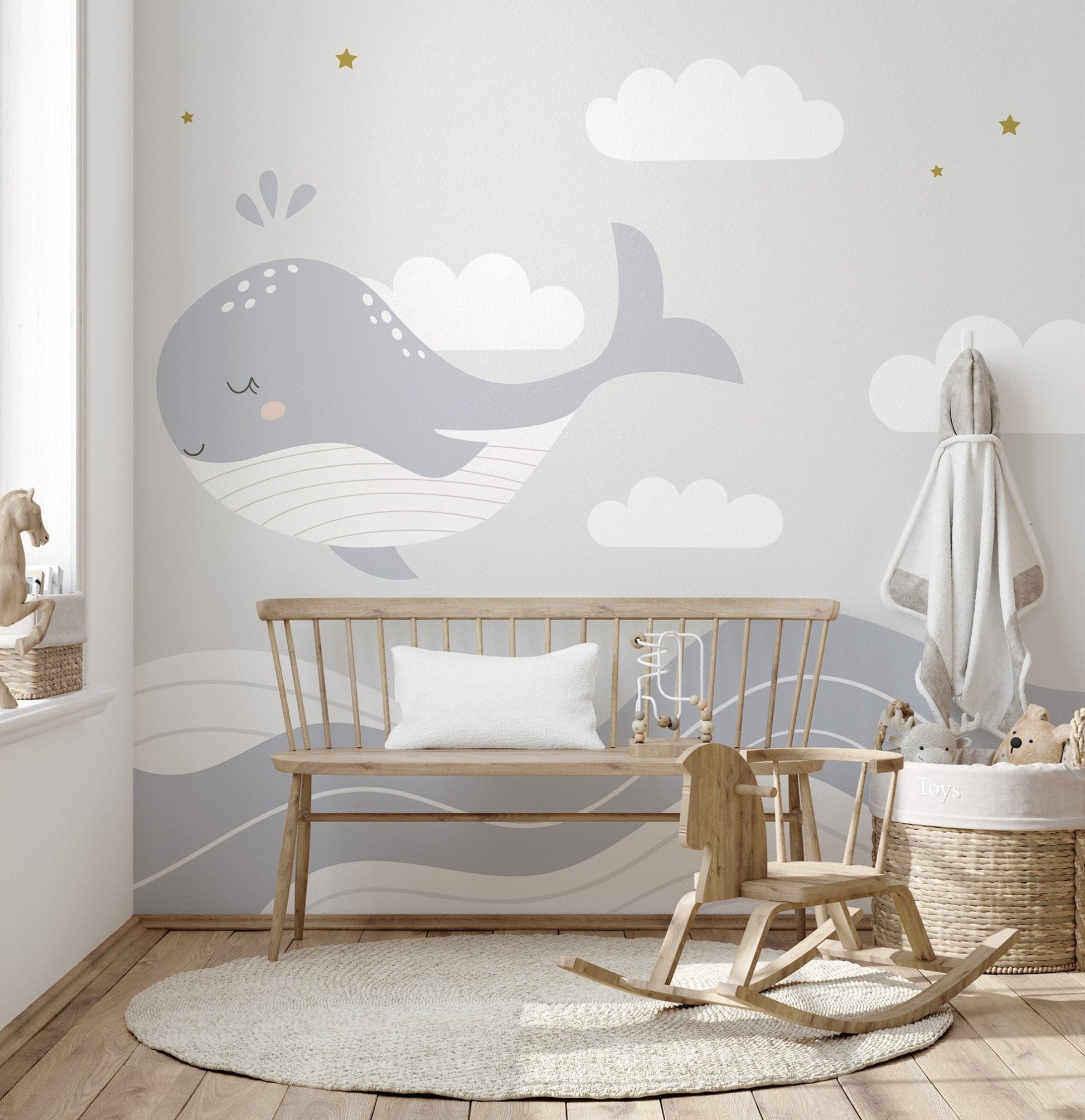 Whimsical whale wallpaper with star accents and wave lines.