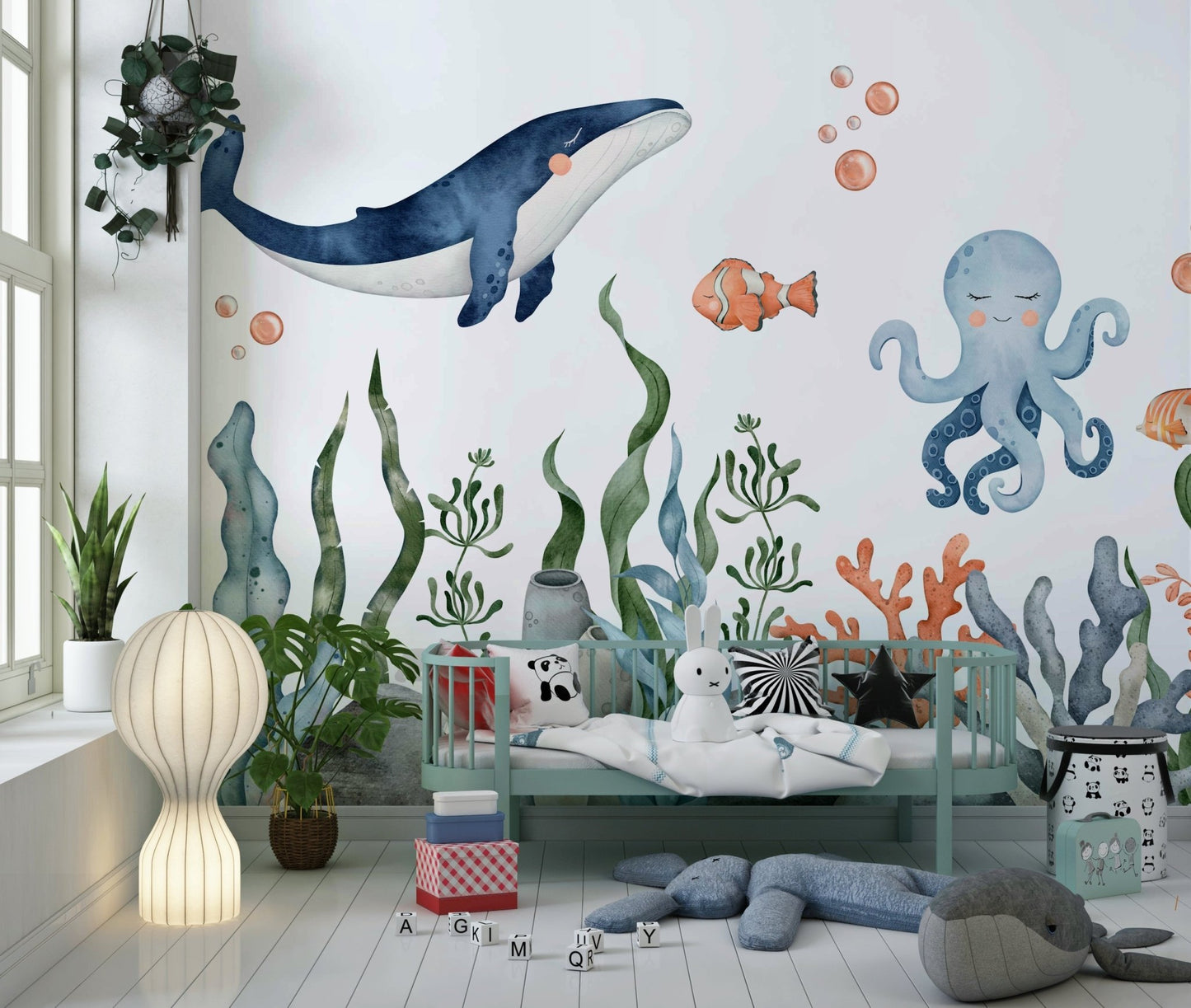 Nursery wall decor featuring soft whale and bubble details.