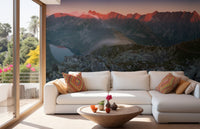 Living room wall mural with white sofa and sunset mountain peaks
