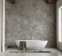 Grey stone effect wall mural in a bathroom behind a white freestanding tub.