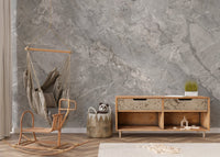 Textured marble wall mural in a minimalist room with a wooden sideboard.
