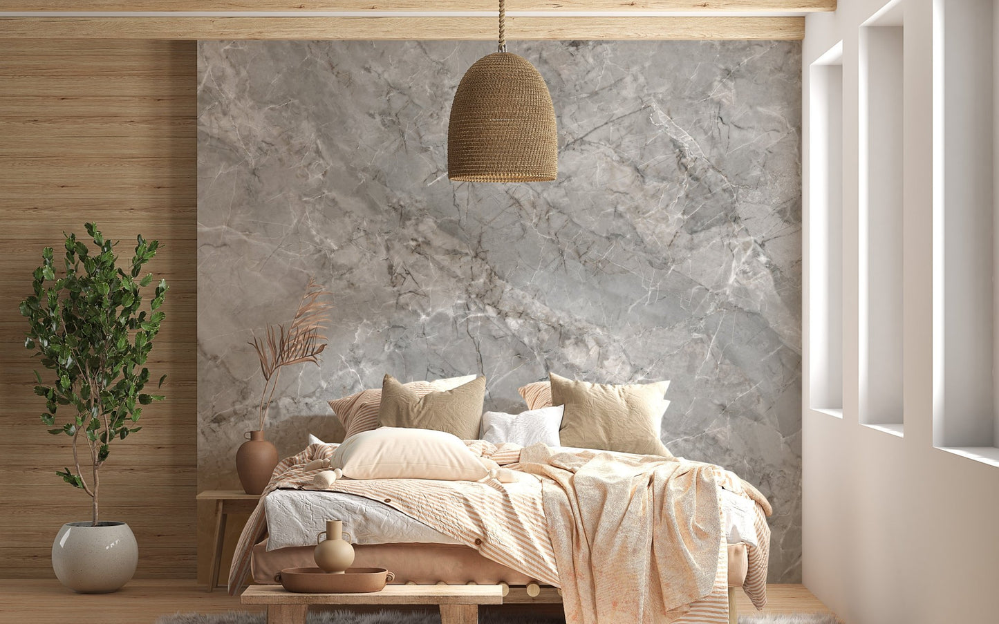 Grey marble wall mural behind a wooden bed frame and wicker pendant light.