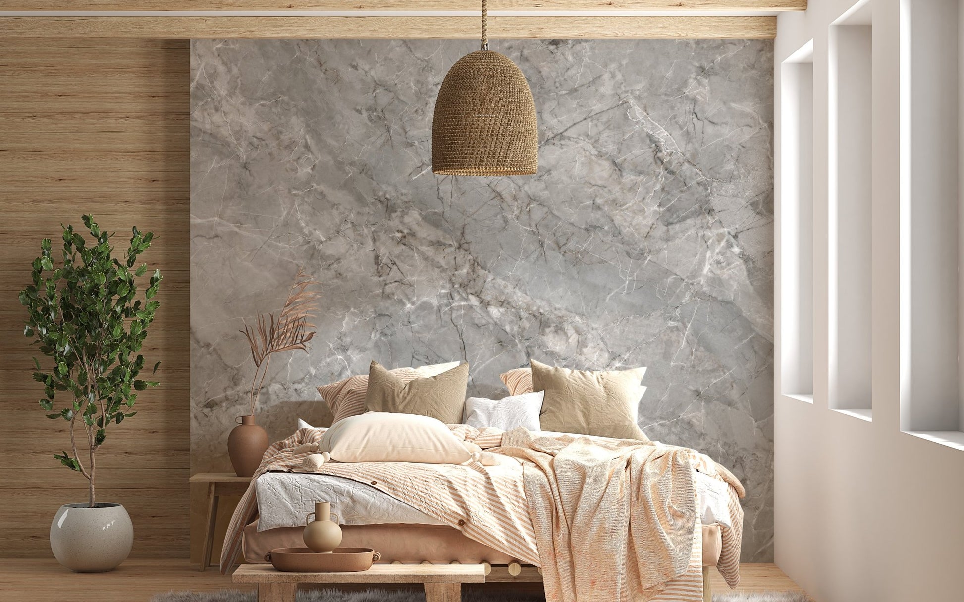 Grey marble wall mural behind a wooden bed frame and wicker pendant light.