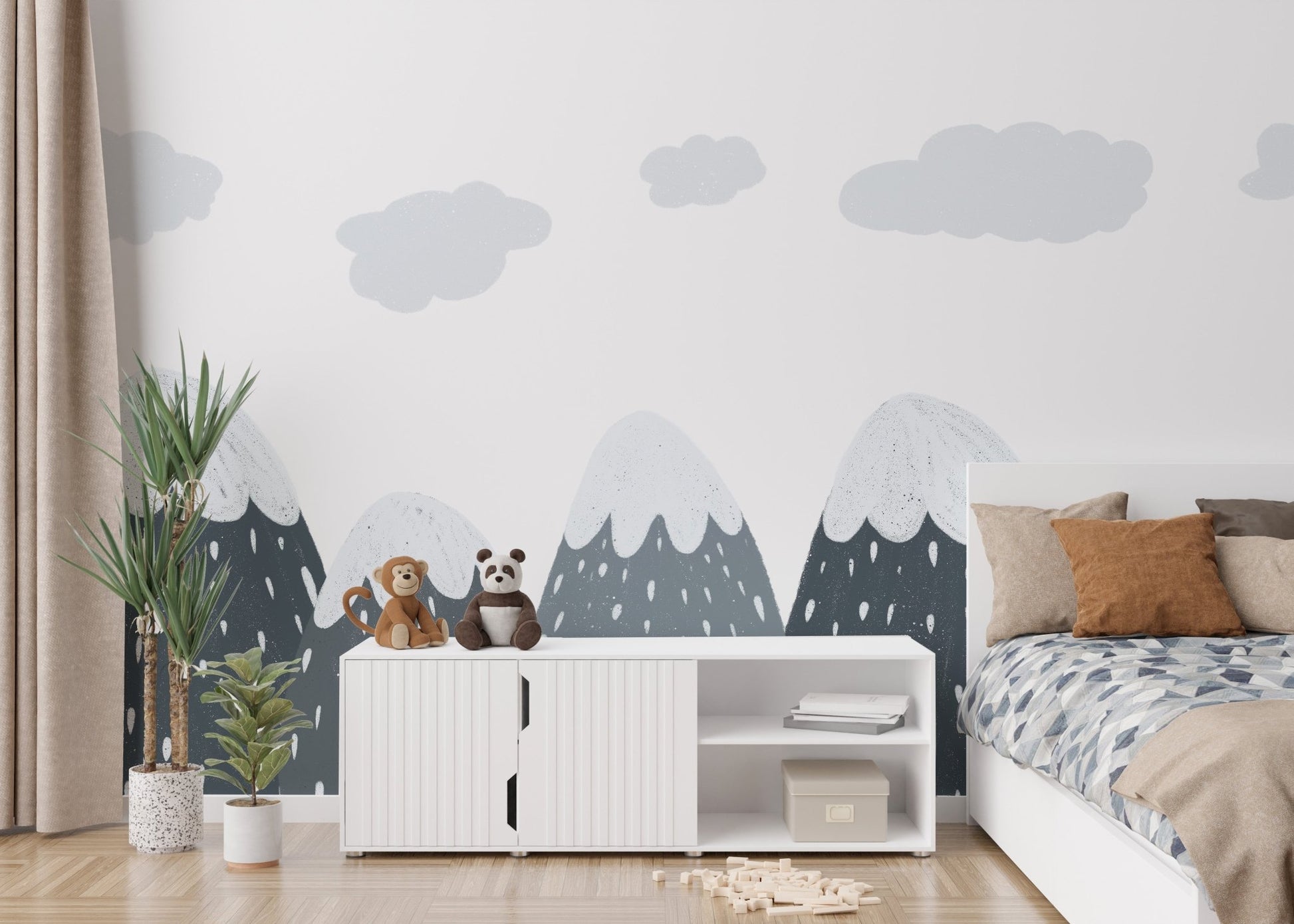 Minimalist mountain wall mural behind a white sideboard and indoor green plants.