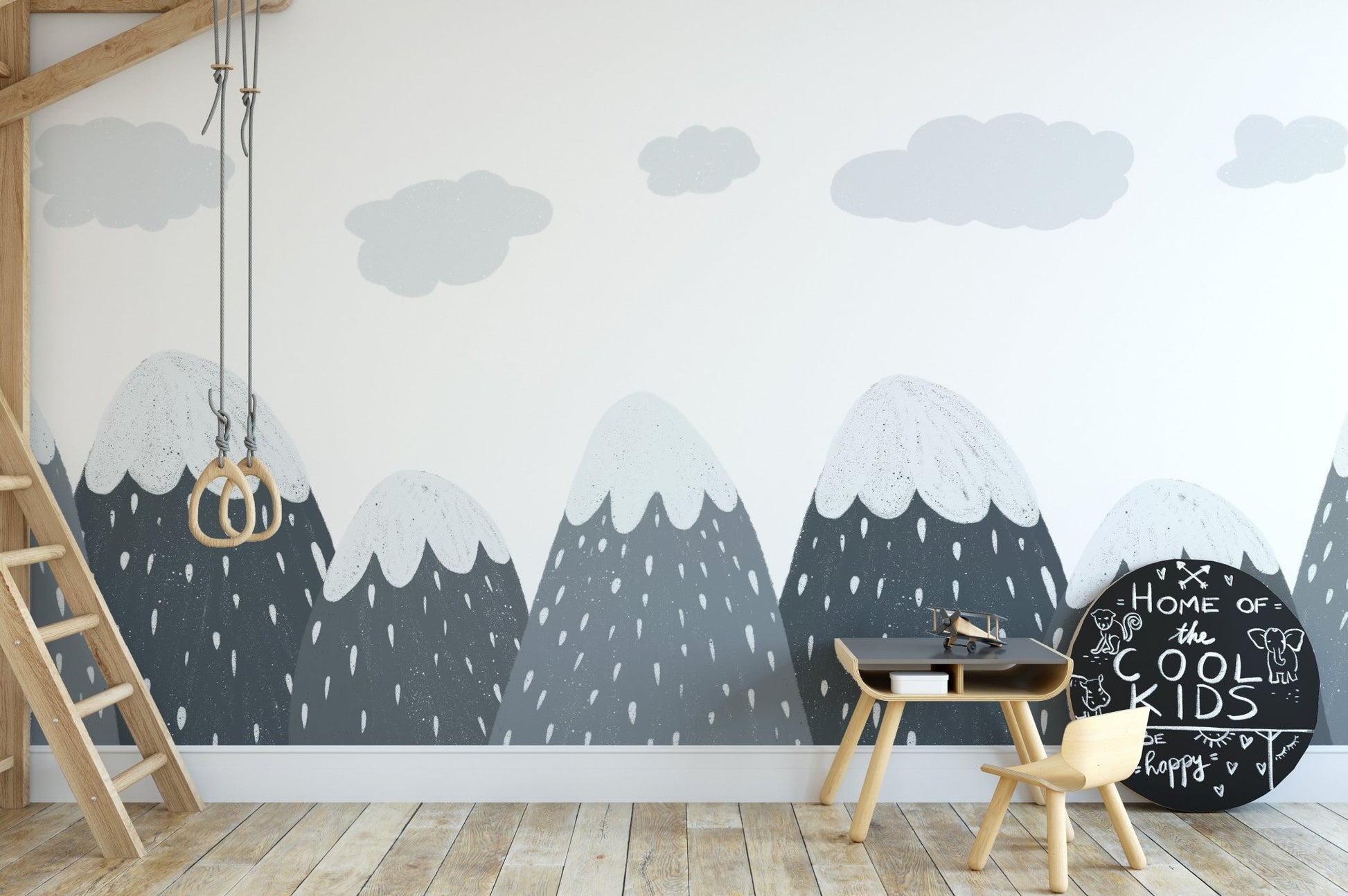 Playroom wall mural featuring mountain silhouettes and a wooden climbing ladder.