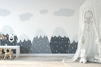 Alpine themed wall mural in a large play space with a white teepee and soft rugs.