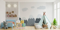 Mountain peak wall mural for a kids bedroom with natural wood furniture and toys.