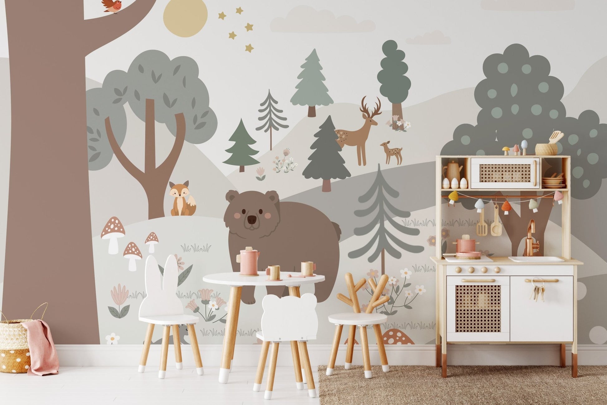 Woodland forest wall mural in a nursery with a white toy kitchen.