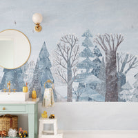 Snowy woodland landscape wall mural in calming pastel blue color.