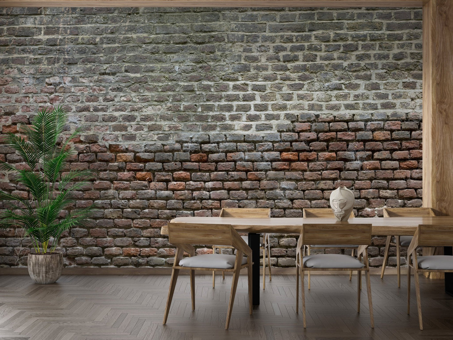 Modern dining space with industrial brick wall mural and green potted plant.