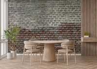 Minimalist dining room showing rustic brick wall mural behind a round table.