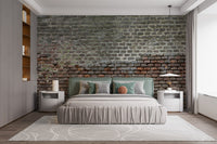 Bedroom setting with grey brick wall mural and neutral bedding.