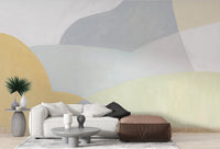 Soft neutral wall mural with abstract waves in yellow and green.