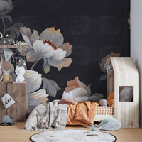 Nursery wall mural featuring dark flower patterns behind a wooden house bed.
