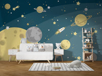 Kids nursery with space adventures wall mural and white wooden storage furniture.