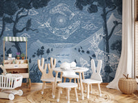 Blue alpine scenery wall mural in a play area with small white furniture.