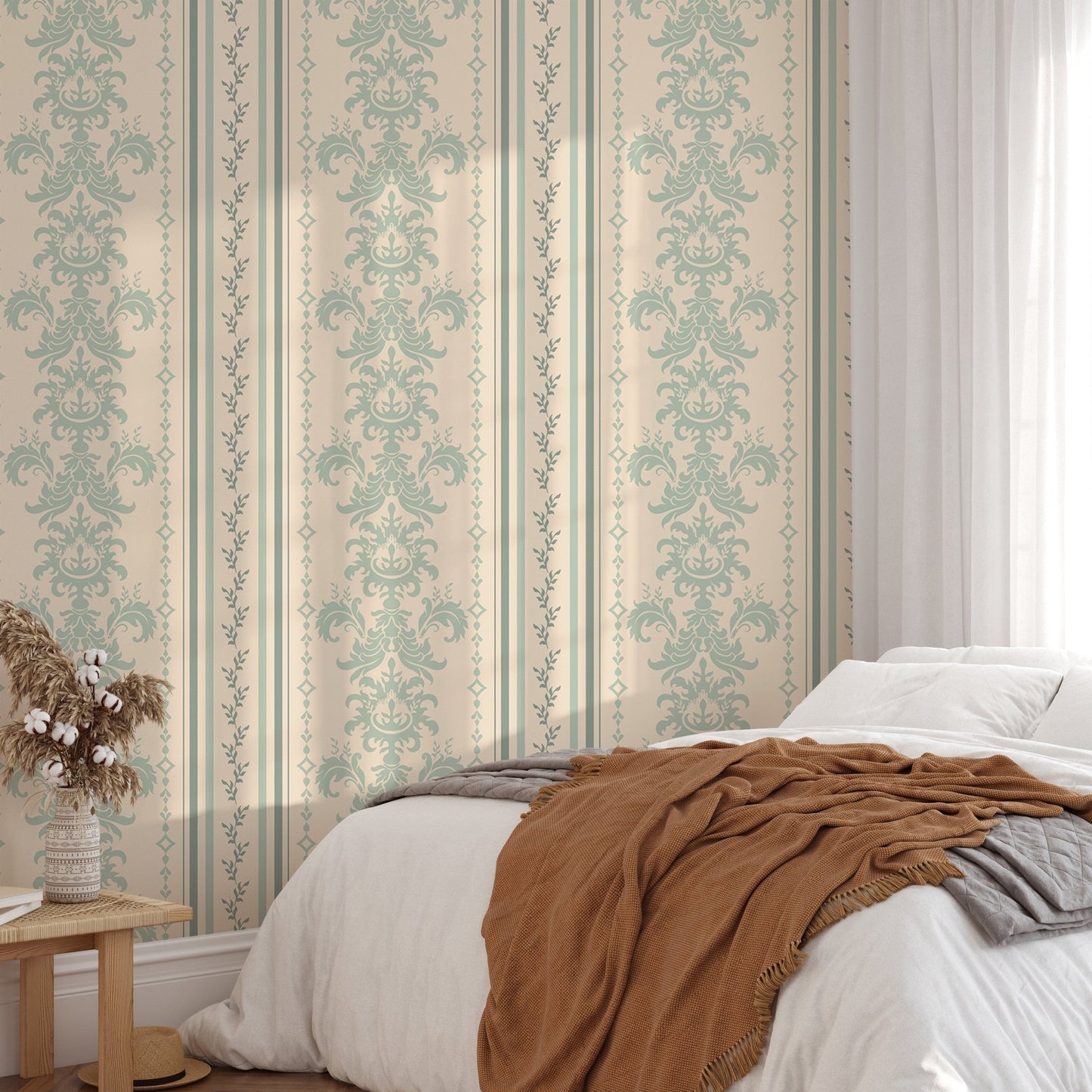 Damask pattern wallpaper in a bedroom with a brown throw and wooden bedside table.