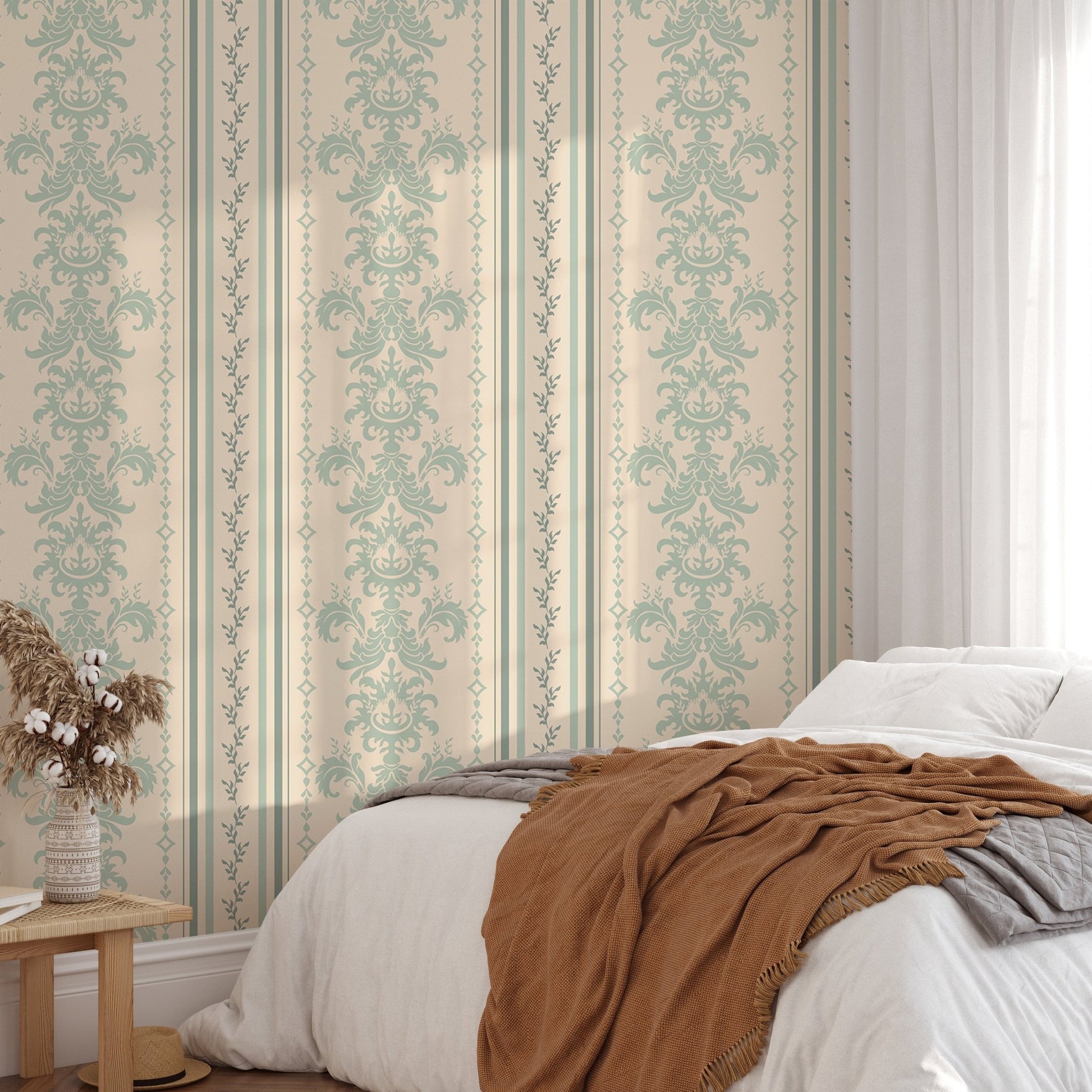 Damask pattern wallpaper in a bedroom with a brown throw and wooden bedside table.