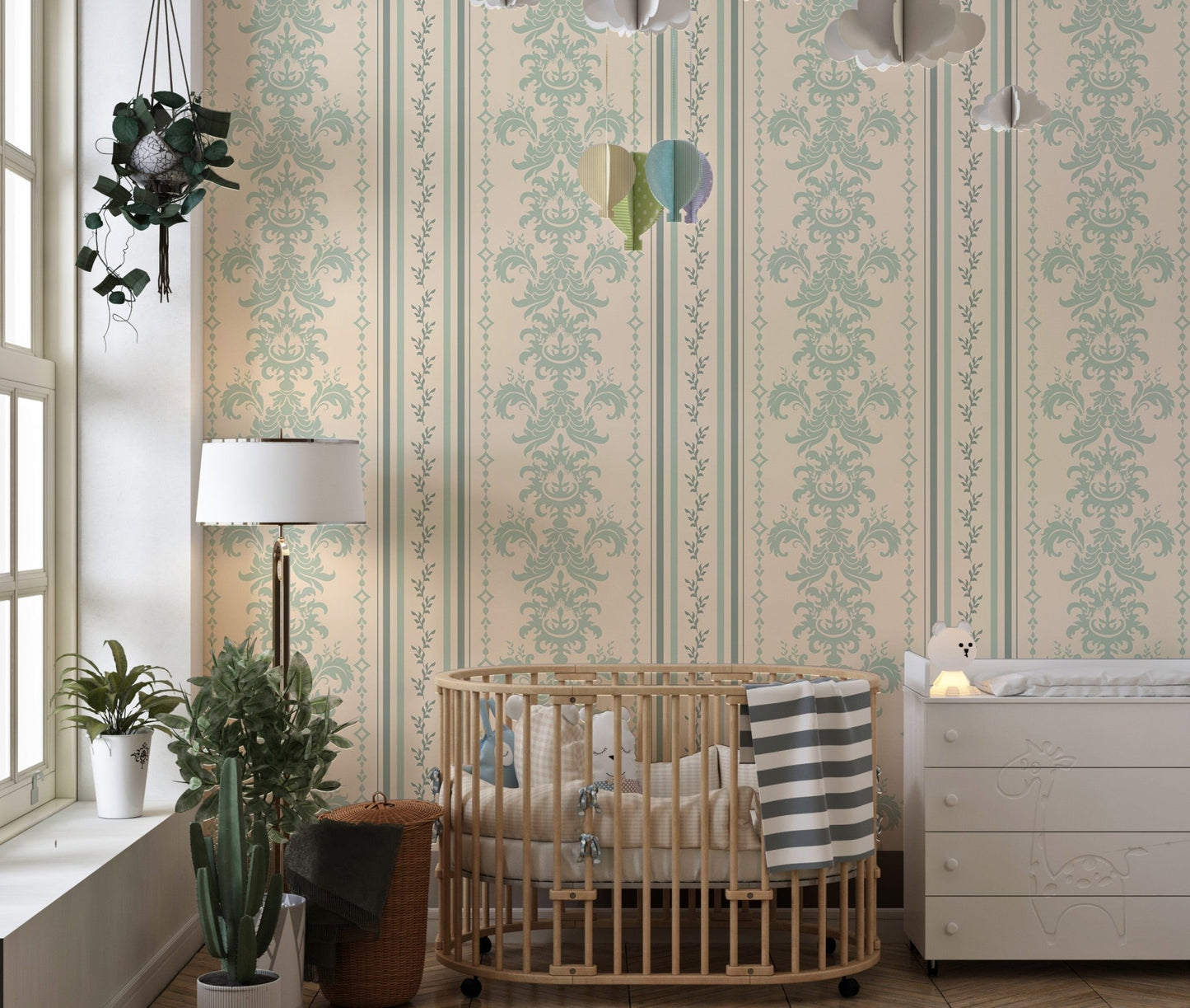 Beige and green damask wallpaper in a nursery with a wooden crib and white curtains.