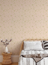 Vintage moon and star print mural on a bedroom wall behind a white pillow.
