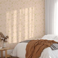 Neutral star pattern wall mural in a sunlit bedroom with a brown textured throw.