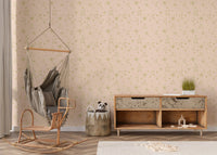 Moon and star pattern wall mural in a nursery area with a hanging swing chair.