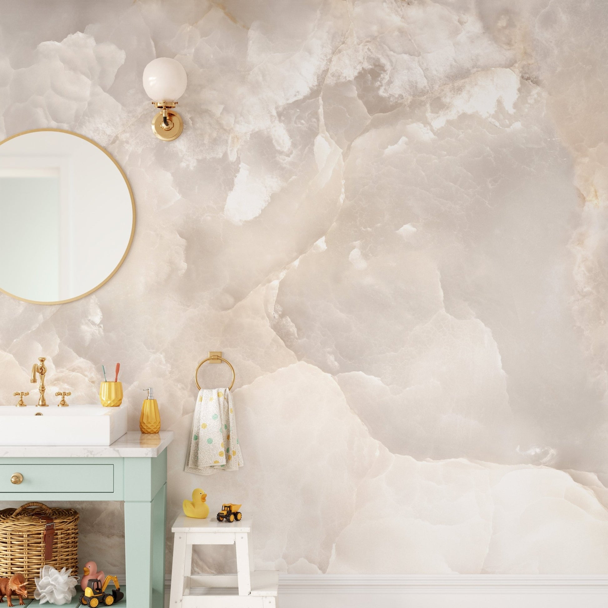 Stone glitter wall mural in a bathroom with a gold mirror and green vanity.