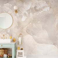 Stone glitter wall mural in a bathroom with a gold mirror and green vanity.