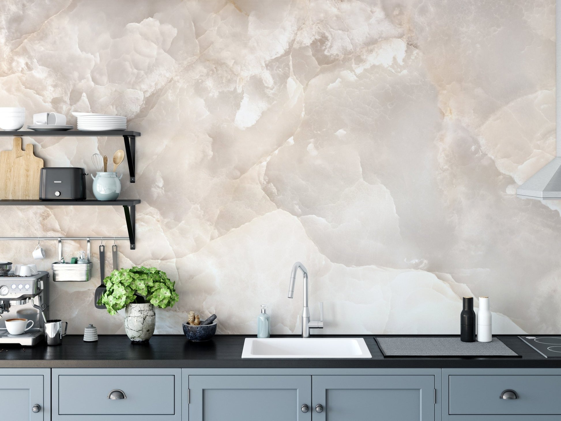 Stone texture wall mural behind a kitchen sink and black cabinetry.