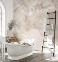 Beige marble wall mural in a bright bathroom with a ladder towel rack.