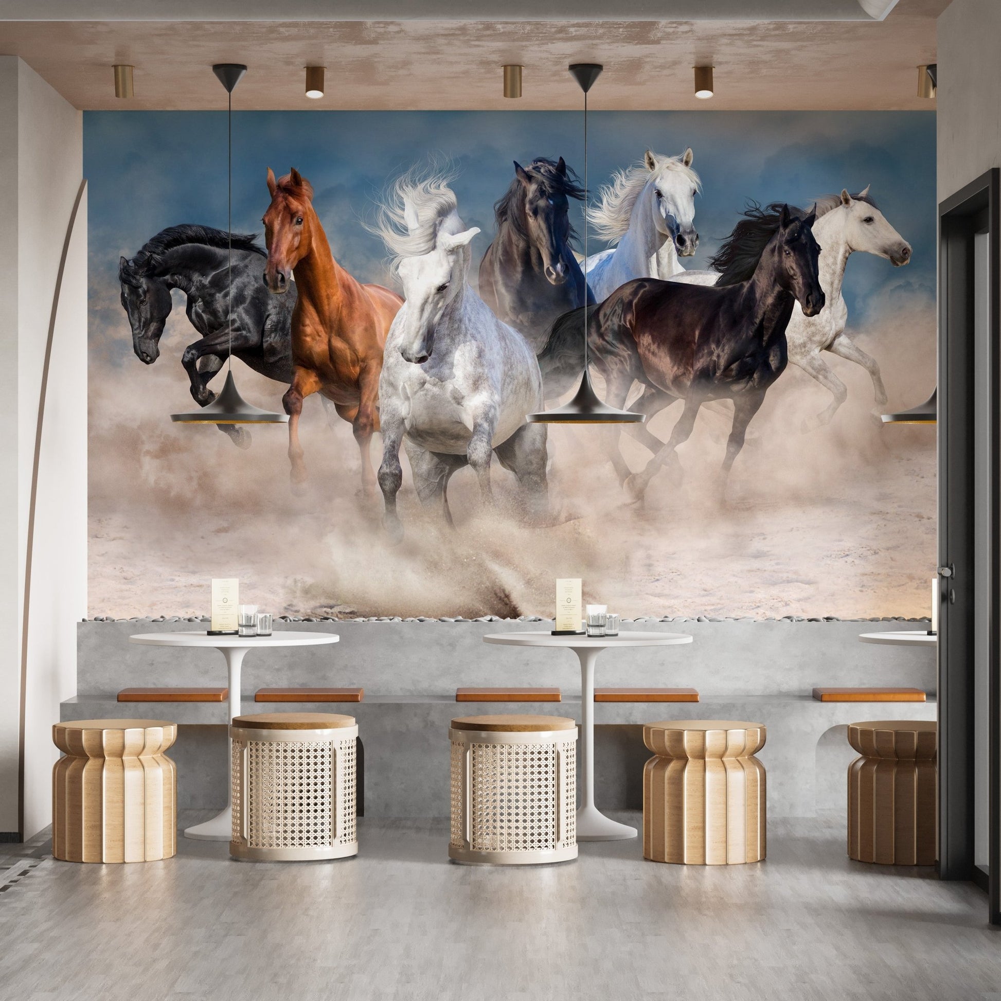 Wild horse wall mural in a cafe seating area with wooden stools and grey walls.