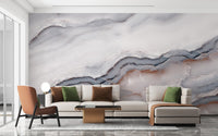 Abstract marble wall mural behind a modern sofa in living room.