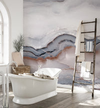 Fluid marble pattern mural in a sunlit bathroom with a white clawfoot tub.