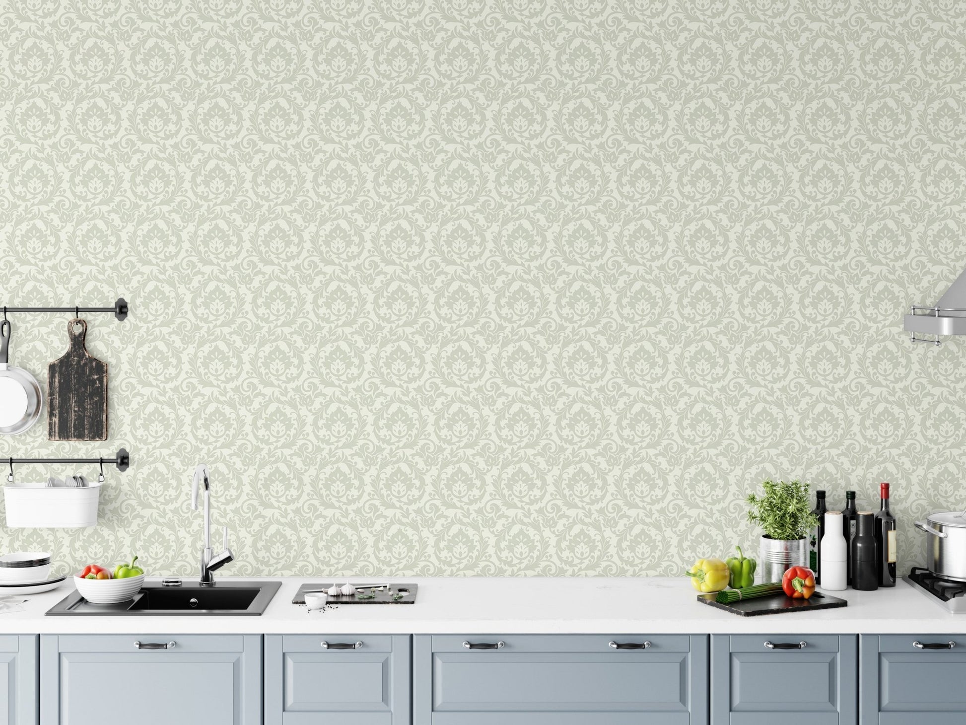 Pale green leaves motif wallpaper in kitchen above white countertop and sink