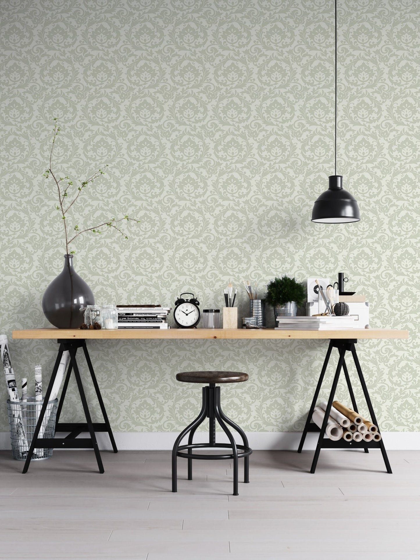 Sage green damask wallpaper in home office with black desk and industrial stool