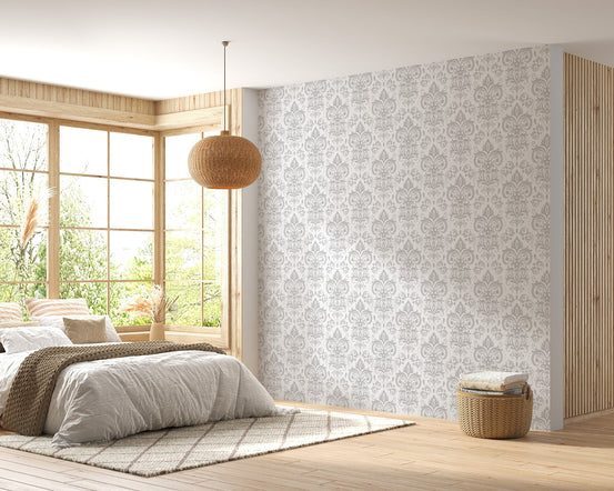 Bedroom interior featuring a damask wallpaper and neutral bedding.