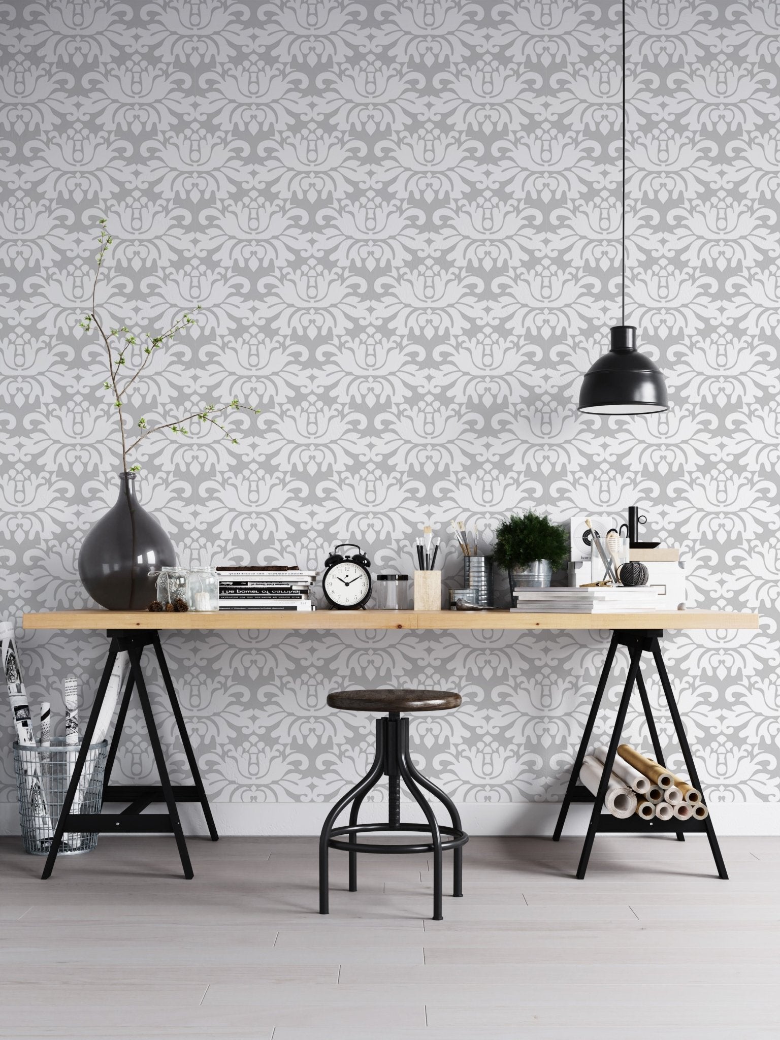 Industrial style home office with a damask wallpaper and black metal desk.