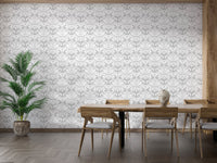 Modern dining room featuring a grey damask wallpaper behind a wooden table set.