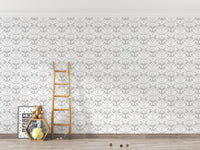 Playroom with a white damask wallpaper and a small wooden ladder toy.