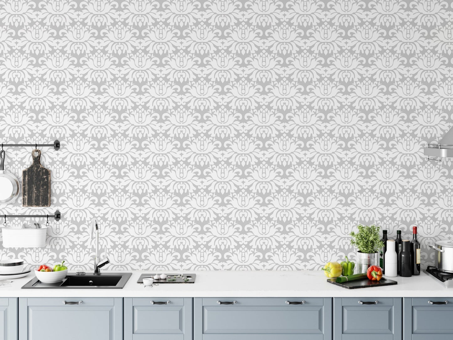 Kitchen area with grey damask wallpaper installed above a white countertop.