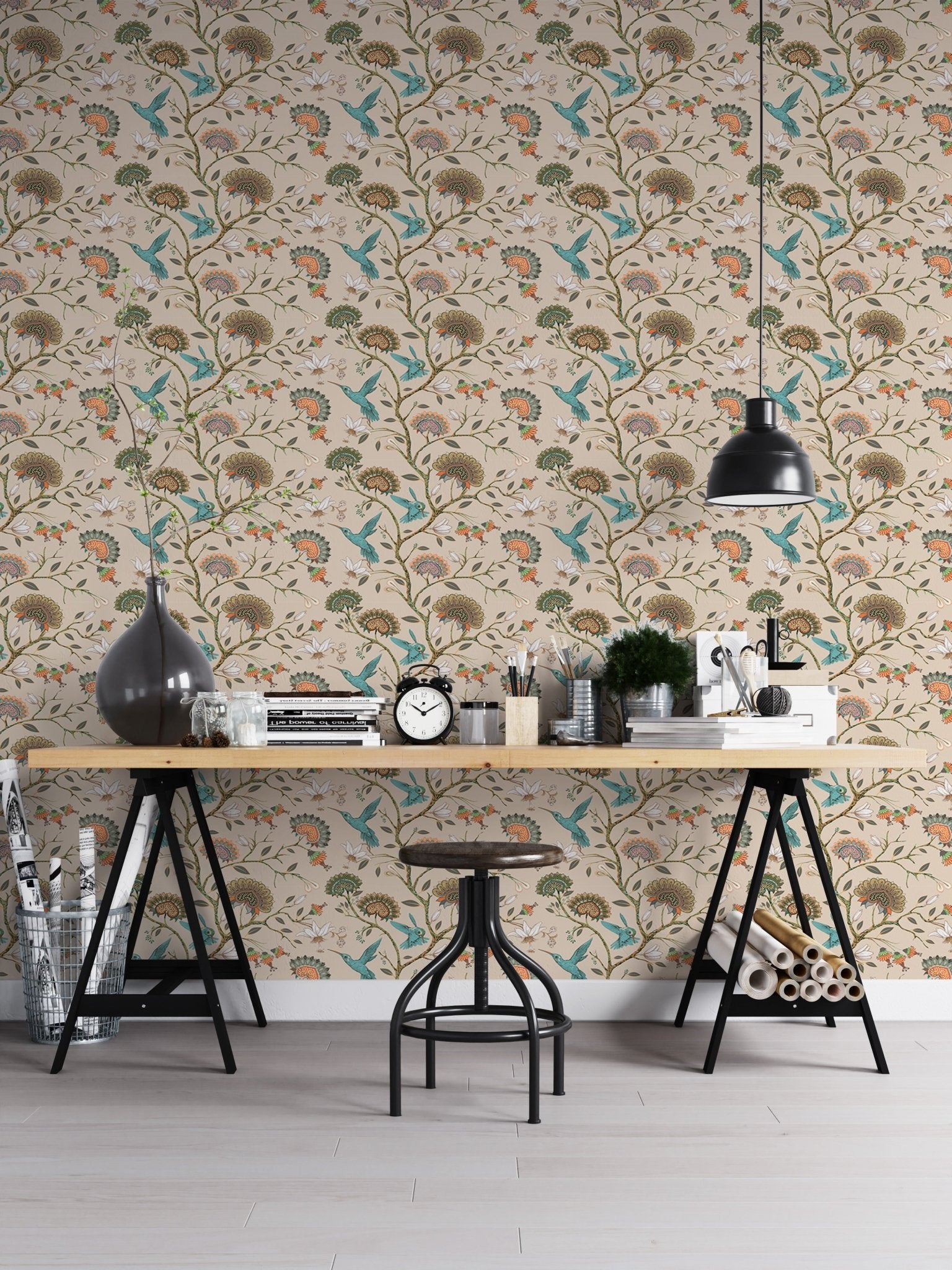 Stylized flowers and humming birds blossom garden wallpaper in a workspace.