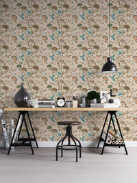Stylized flowers and humming birds blossom garden wallpaper in a workspace.