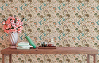 Stylized flowers and humming birds blossom garden wallpaper behind a wooden table.