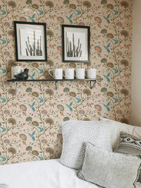 Floral wallpaper featuring hummingbirds on a living area wall with framed art.